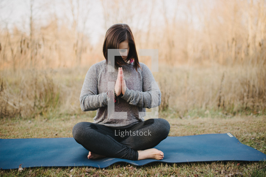 a woman doing yoga outdoors 