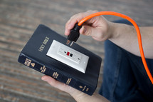power of scripture - Bible with an outlet and power cord about to be plugged in