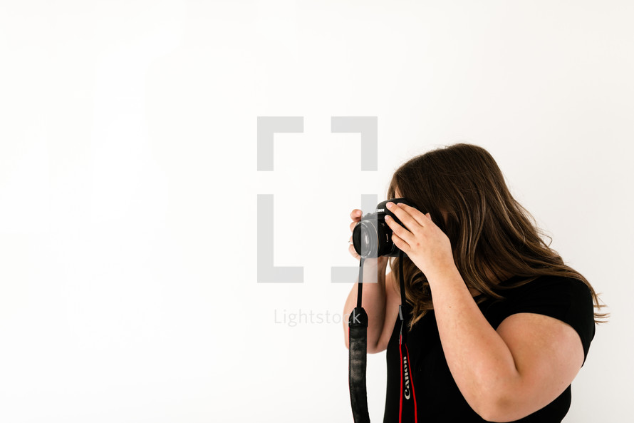 a woman taking a picture with a camera 