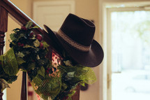 hat on a railing and garland 