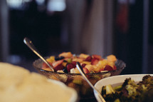 bowls on fruit and vegetable servings on a dinner table 