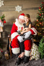 girl sitting on Santa's lap 