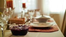 cranberry sauce on a table set for thanksgiving 