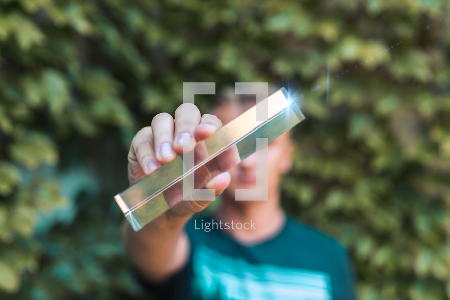 a man holding a prism 