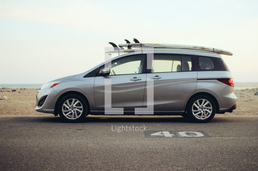 surfboards on the top of a minivan 