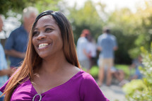 headshot of an African American woman at a backyard summer party 