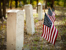 Memorial day, American flags beside very old grave markers, fallen but not forgotten