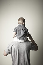 A boy sitting on his Dad's shoulders