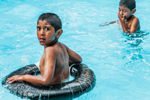 boy child in a float in a pool 