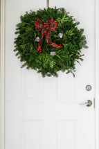 Christmas wreath hanging on a door 
