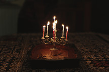 a fancy set of candles on a home made birthday cake