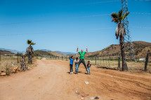 man and children on a dirt road in Mexico 