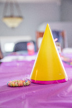 birthday hats and a candy bracelet on a table 