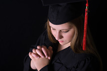 graduate with praying hands 