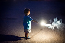 toddler boy holding a sparkler 