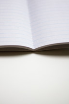 lined paper in an open notebook 