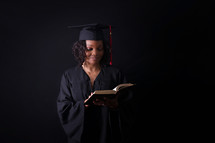 graduate reading a Bible 