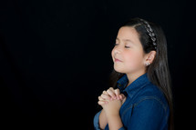 A girl with praying hands 