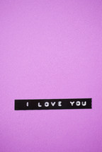 "I love you," on a purple background.