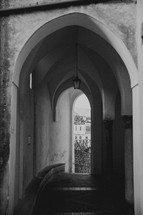arched tunnel over a narrow street in Italy 