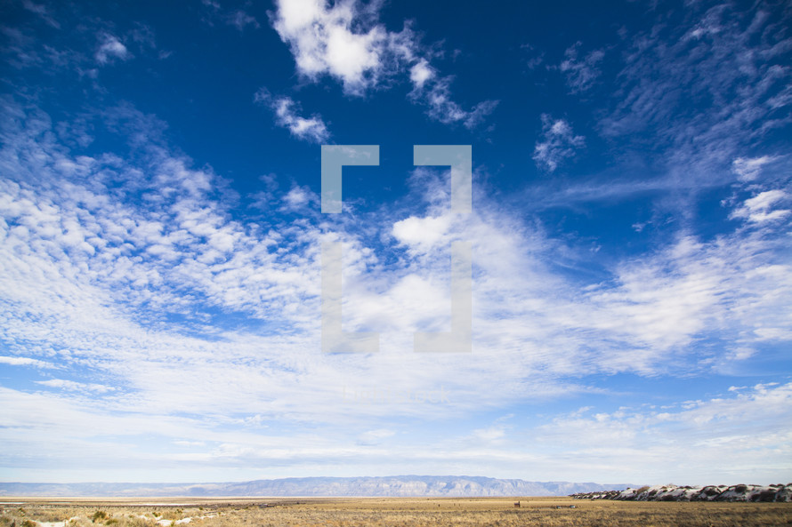 plains and mountains and blue sky
