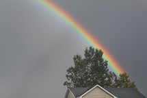 rainbow over a house roof 