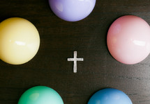 Cross surrounded by colorful Easter eggs.