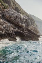 waves crashing into a rocky shoreline 