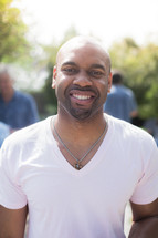headshot of an African American man at a backyard party 