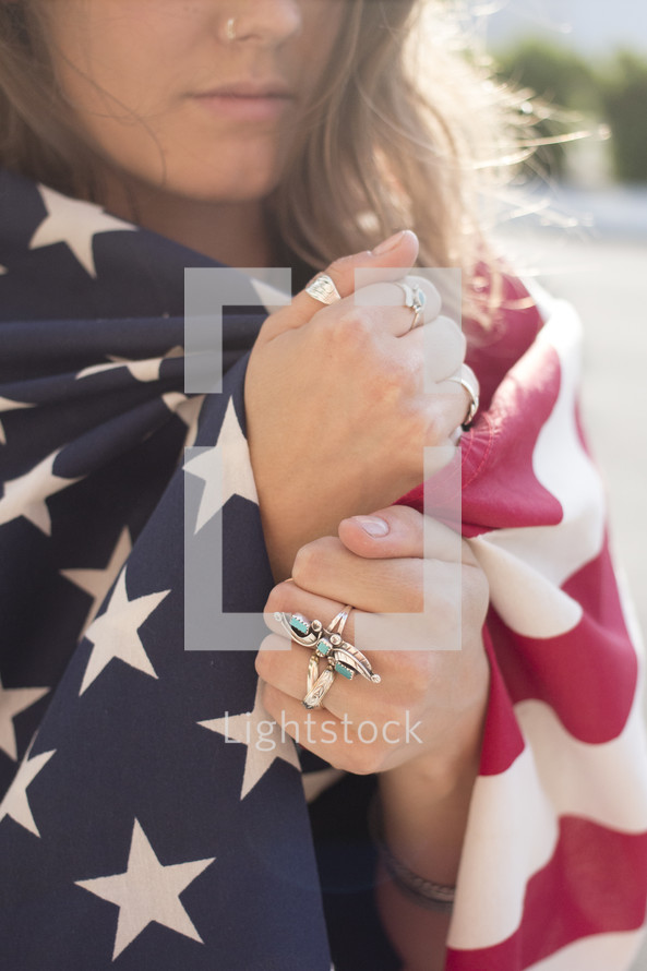 A young woman wrapped in an American flag 