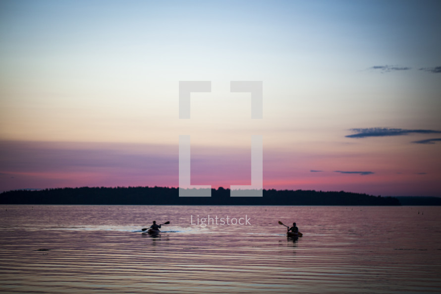 kayaking on a lake at sunset 