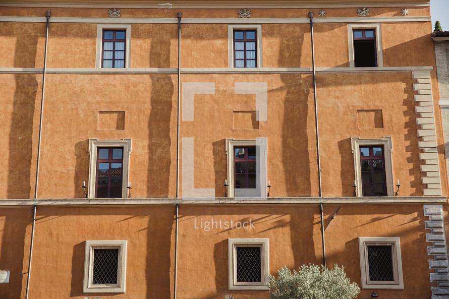windows on the side of a building in Rome