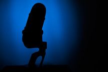 microphone silhouette on blue 