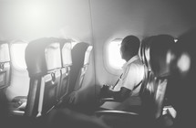 a man sitting alone on an airplane 