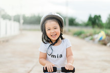 a little girl on a scooter 