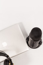 headphones, microphone, and laptop computer on a white background 