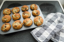 chocolate chip muffins and oven mitt