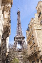 view of the Eiffel tower between buildings 