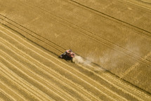 Combine harvester harvesting a wheat field