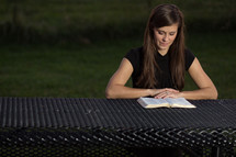 Female reading Bible outdoors