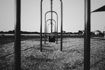 empty swings on a playground 