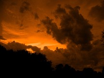 An orange sky lights up the night as the sun sets 