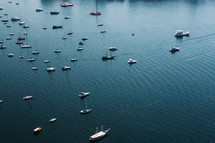 aerial view over anchored boats in a bay 