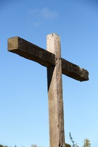 A wooden cross against a blue sky.