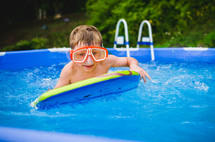 a little boy in a swimming pool 