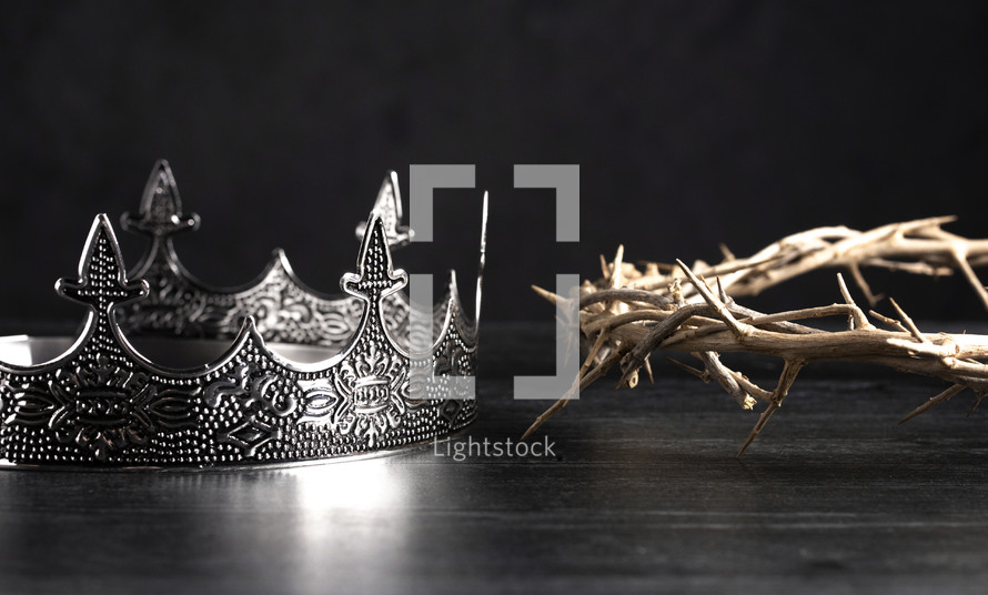 crown and crown of thorns on a wooden background 