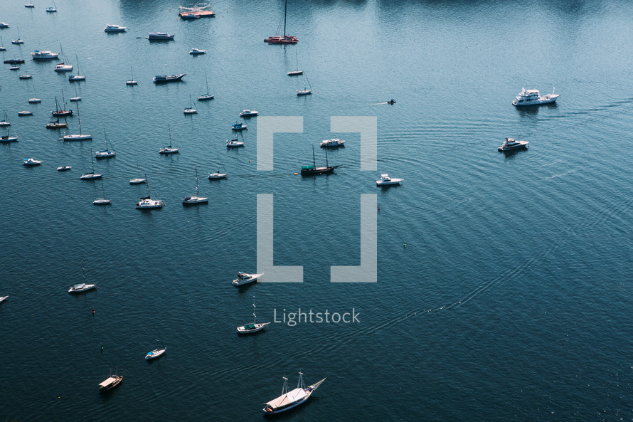aerial view over anchored boats in a bay 