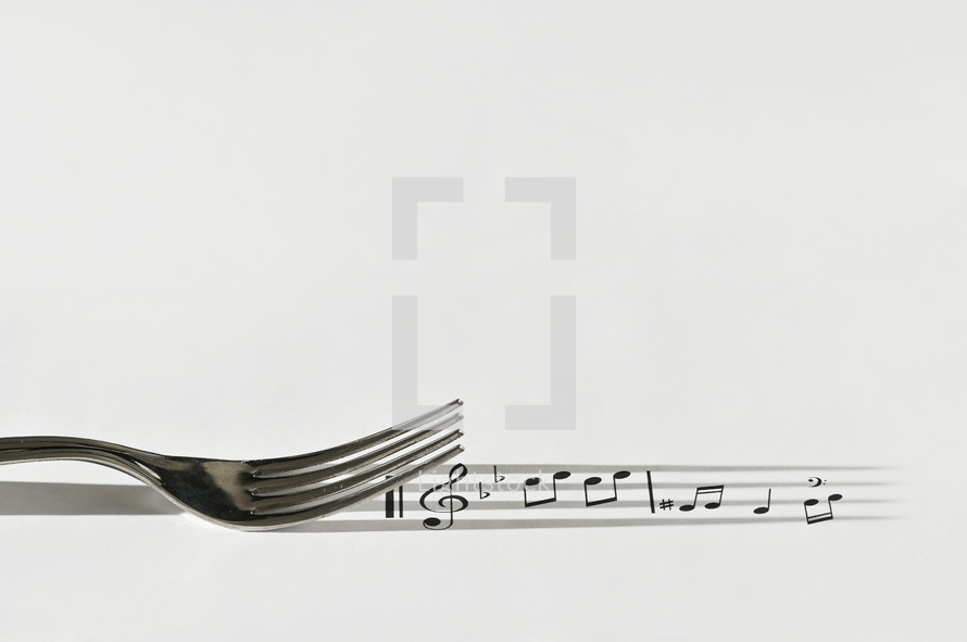 stainless Steel Fork and Shadow like Music Sheet Or Score And Musical Notes