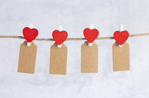 red hearts with felt tags on a clothesline 