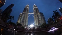 Timelapse of people by Petronas Towers from evening till night